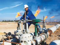 FILE - In this Jan. 12, 2017 file photo, a worker operates valves in Nihran Bin Omar field north of Basra, Iraq. The U.S. has signaled to Iraq it's willingness to extend sanctions waivers enabling the country to continue importing vital Iranian gas and electricity imports, three Iraqi officials said this week. The decision comes amid strained U.S.-Iraqi ties following last month's Washington-directed airstrike that killed a high-profile Iranian general on Iraqi soil. (AP Photo/Nabil al-Jurani, File)