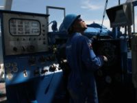 (left) Schlumberger's drilling operator Adrian Gabriel (cq) is directly in charge of drilling operation on the Genesis Drilling Test Facility where other employees train with a real life size drilling simulator which was commissioned in 1986 at company's U.S. headquarters in Sugar Land and continues to train on Wednesday, September 27, 2006. Schlumberger is the world's largest oilfield services company and has had a local presence since the 1930s; it recently consolidated its New York offices in Houston. Schlumberger is coming off a record quarter and anticipates solid financial growth as profit-rich oil companies invest more in exploration. Photo by Mayra Beltran / Houston Chronicle