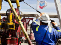 Exxon reports a historic loss while Chevron deepens capex cuts