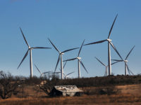 Wind turbines tower over a building on a farm in Colorado City, Texas, on Jan. 21, 2016. Spencer Platt/Getty Images