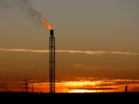 FILE PHOTO: A flare burns excess natural gas in the Permian Basin in Loving County, Texas, U.S. November 23, 2019. REUTERS/Angus Mordant