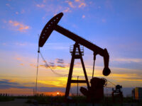 Oil pumping Unit at sunset time